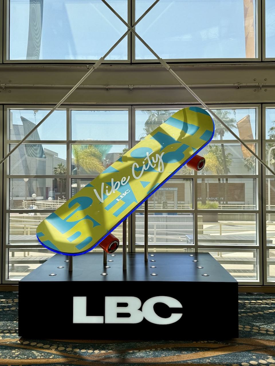 skateboard sculptuire with “Vibe City LBC” on the board