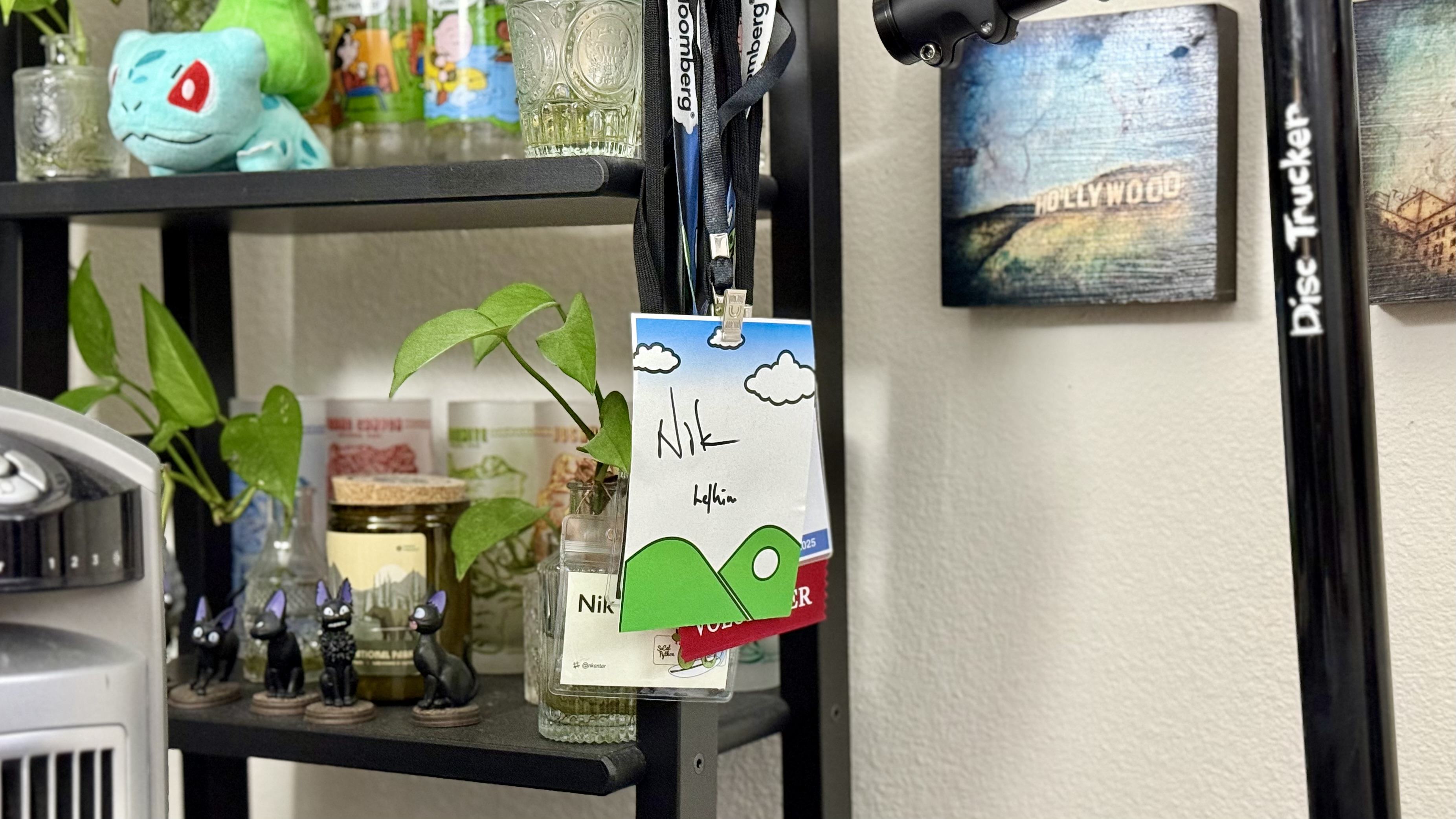 NPBy badge with “Nik” and “he/him” scribbled on it with a marker